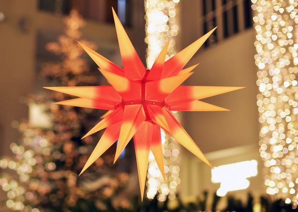 A moravian star made of paper hanging from the ceiling